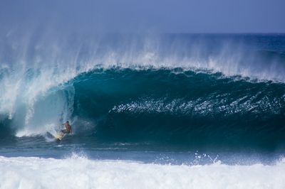 Pulling into a second reef Pipeline tube